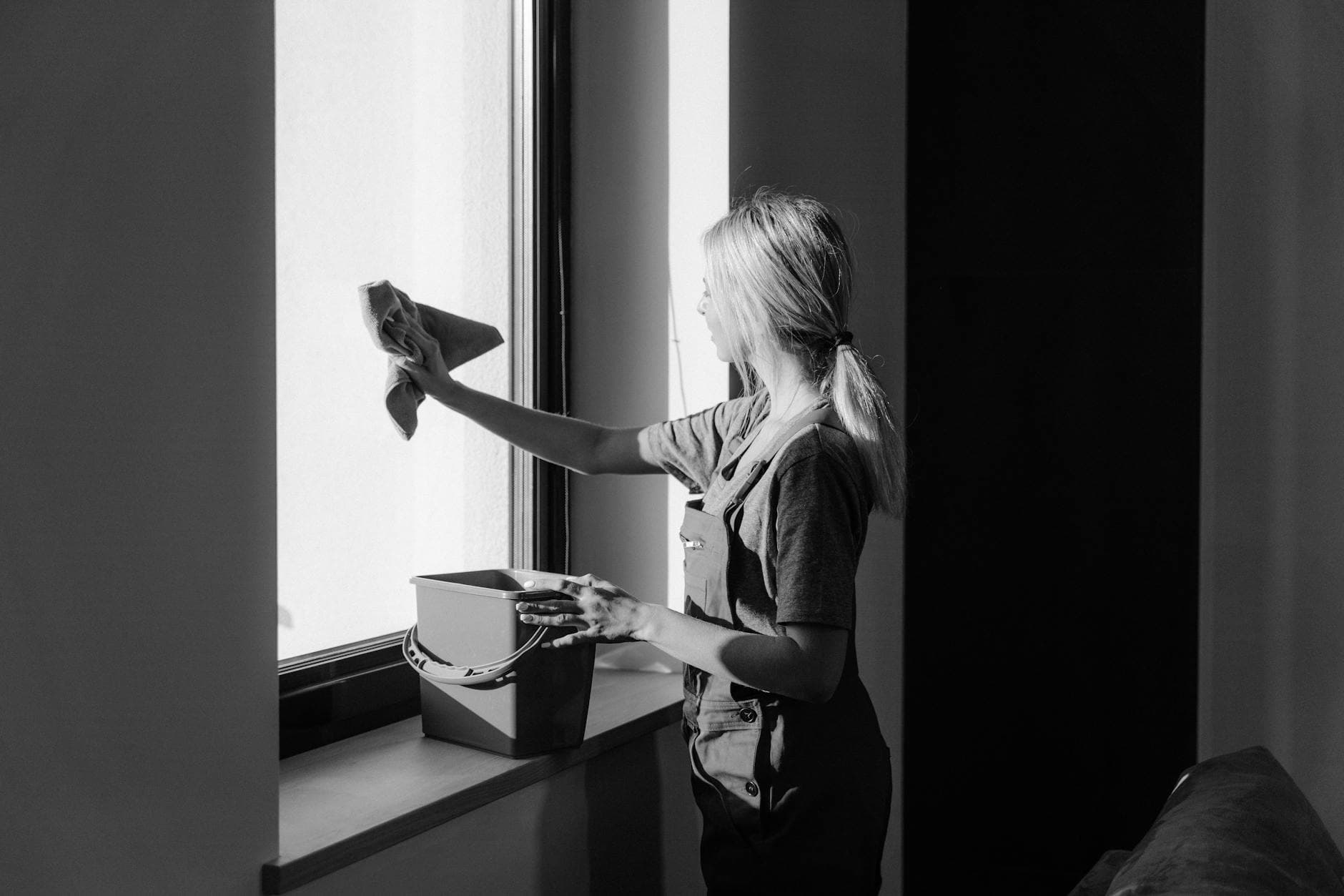 Professional window cleaning in a Long Island apartment using cloth and bucket — How to Clean High-Rise Apartment Windows in Long Island (Safely)